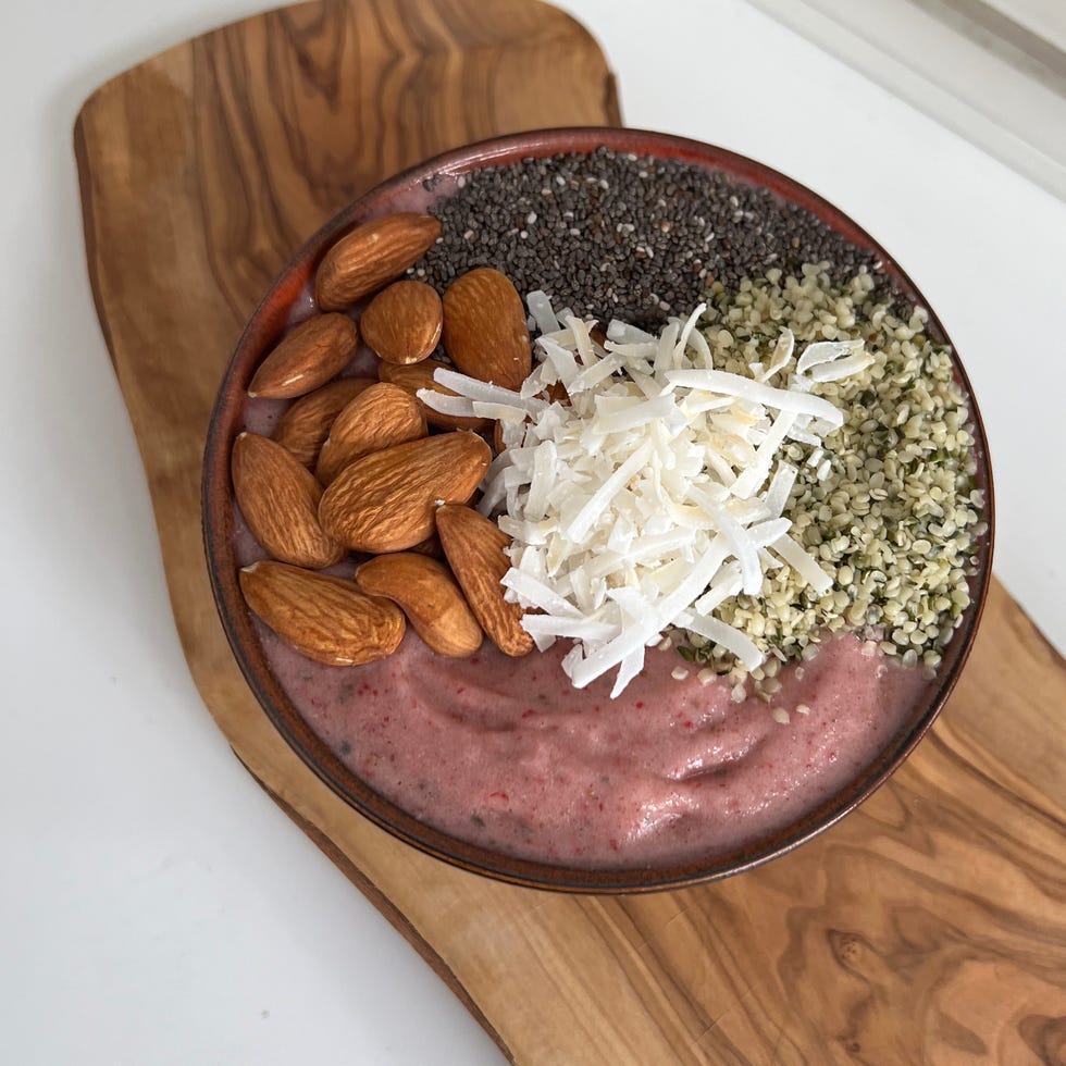 A strawberry smoothie bowl with protein powder, almonds, chia seeds, hemp hearts and coconut for a total of 40 grams of protein.